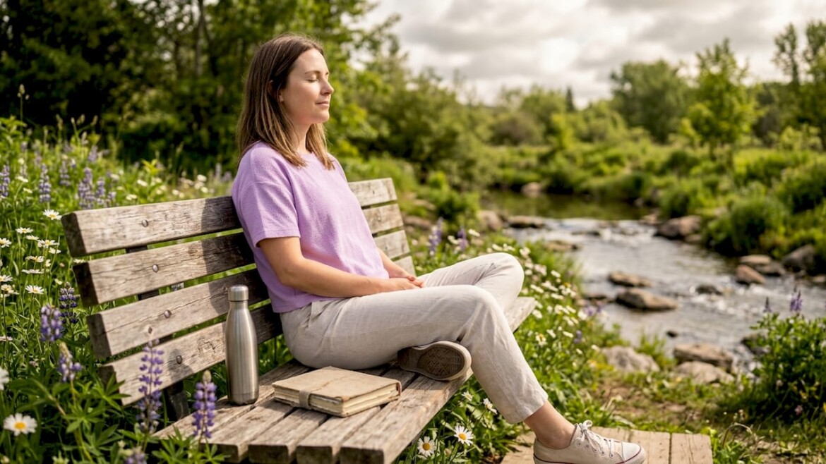 Woman practicing mindful outdoor break on park bench