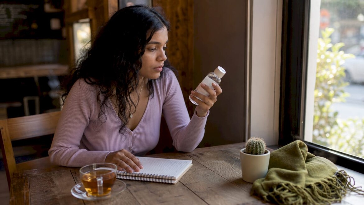 Person reading skincare product label