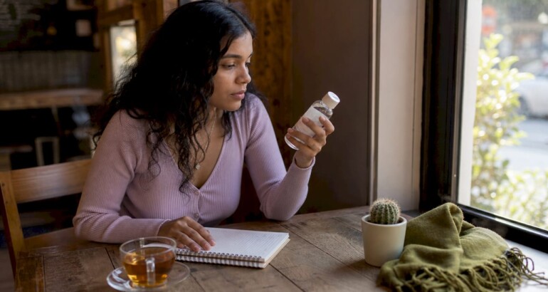 Person reading skincare product label