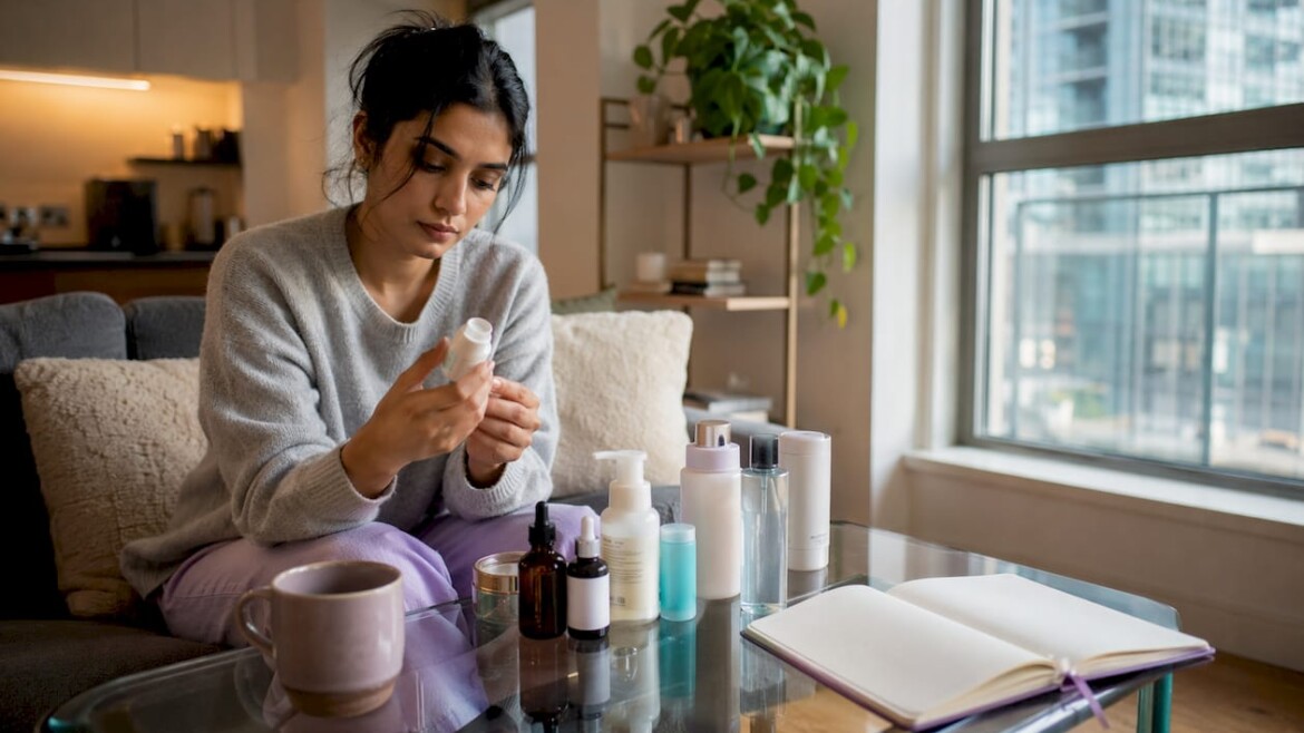 Woman comparing skincare products at home