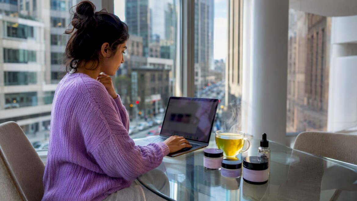 Woman researching skincare alternatives at home