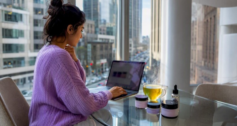 Woman researching skincare alternatives at home