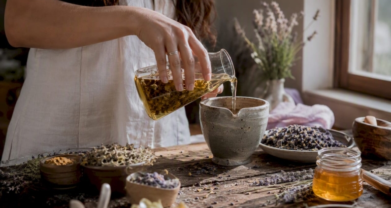 Hands mixing natural skincare ingredients in bowl