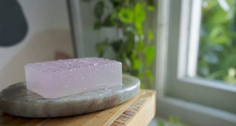 Glycerin soap bar on wooden soap dish