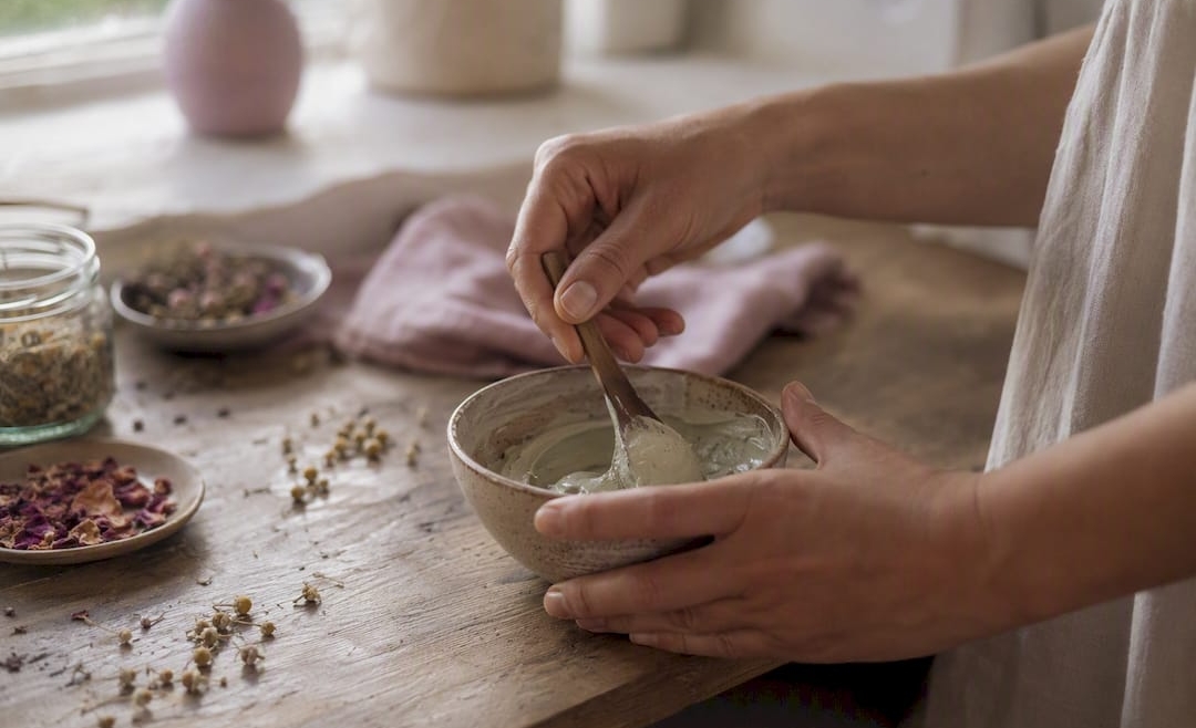 Hands mixing botanical facial mask