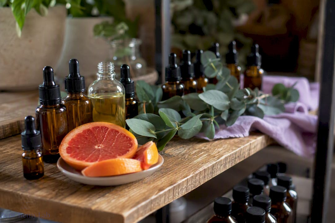 Amber bottles of natural and fragrance oils with botanicals