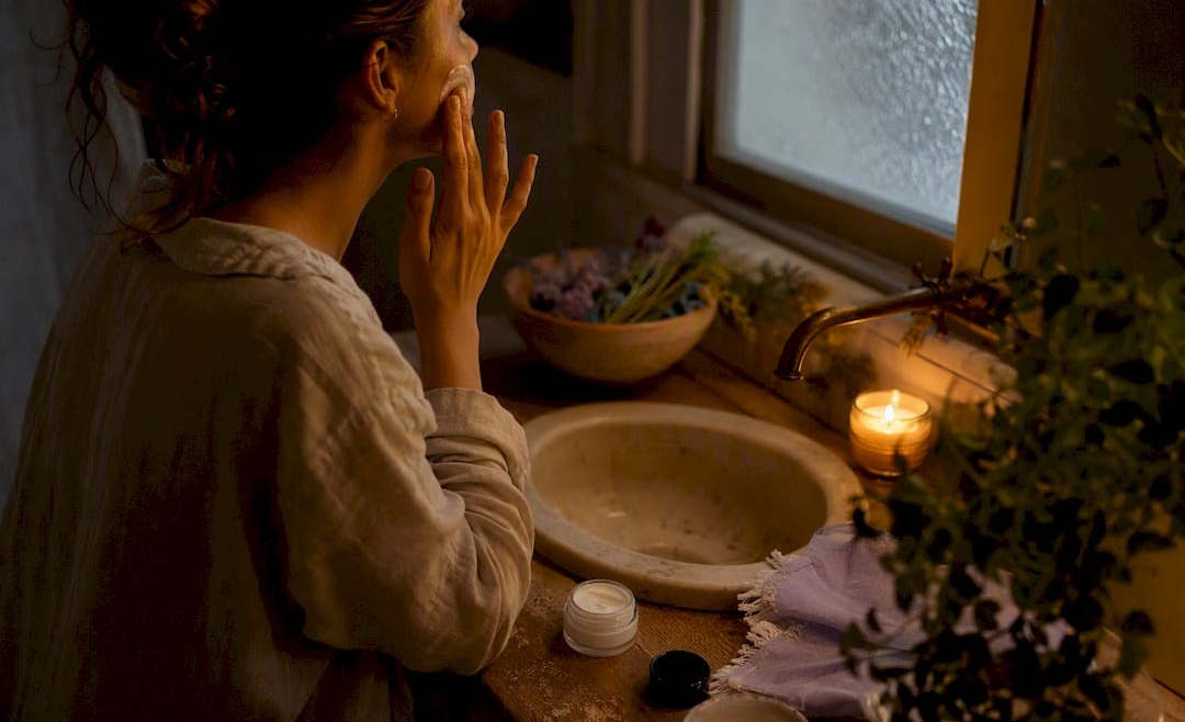 Hands applying moisturizer in evening skincare ritual