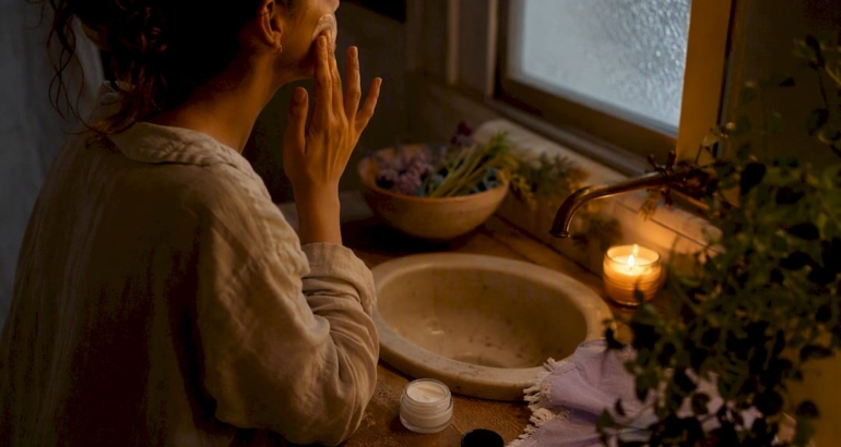 Hands applying moisturizer in evening skincare ritual