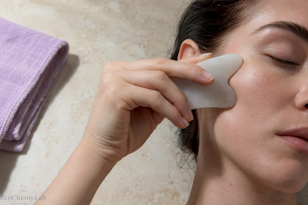 Gua sha stone tracing a cheekbone