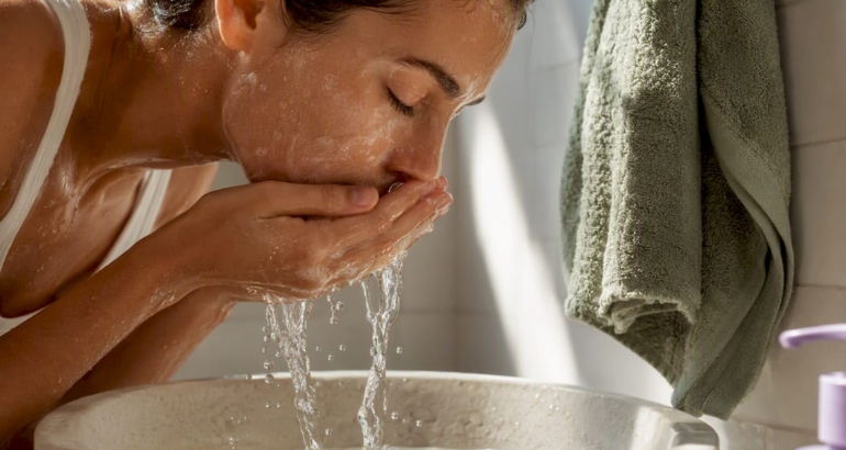 Person rinsing cleanser from sensitive skin