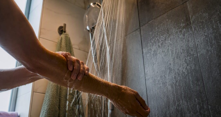 Hands rinsing hard-water residue from skin