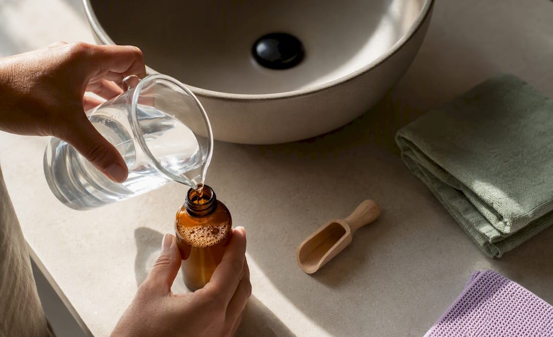 Hands preparing diluted Castile soap